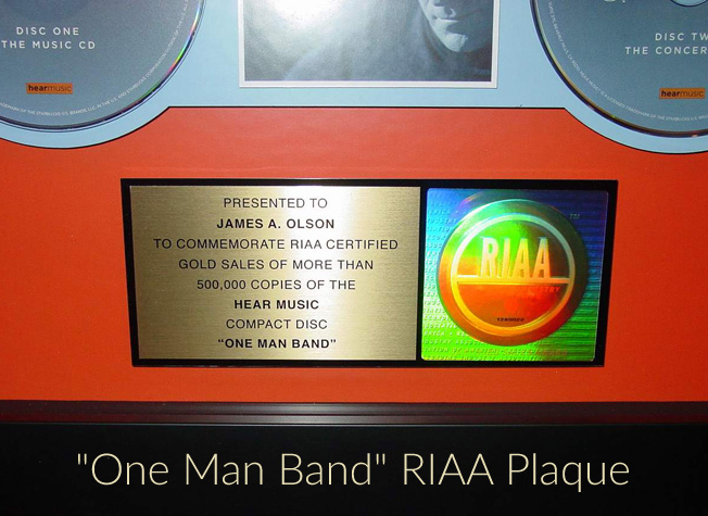 James Taylor presents Jim Olson with a “One Man Band” RIAA Plaque