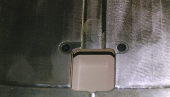 A a detail of one of the slots in the routing template for trimming the end of the center strip