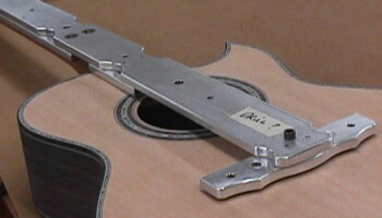 This jig is used to drill the locating holes for the bridge and to correctly place the ( laser cut ) mylar mask that will keep finish from getting on the guitar top.