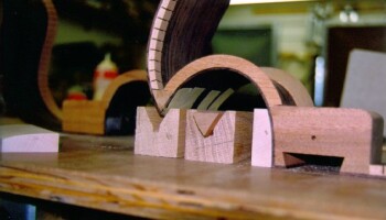 Calls for gluing the cutaway to the headblock and corner block. An extra corner block is shown. The headblock curve must be carefully machined to shape the cutaway; this is done on the Fadal, as is cutting of corner blocks