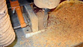 With the headblock located on a pin, the cut-away contour can be cut on the block. Any fingerboard width can be easily achieved