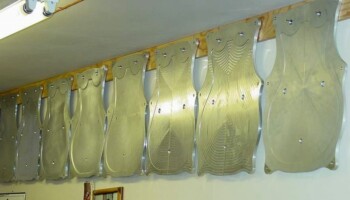 These are radiused gluing cauls used to glue on the tops and backs of the different sized guitars