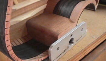 After the top is glued on, this jig—yet another Fadal creation—is used to to drill a reference hole in the headblock to guide further assembly