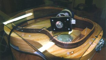 This plexiglass fixture guides a router for making slots in the lining to receive the back and top braces