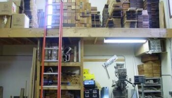 Wood storage on a "loft" on the main floor. The Bridgeport is on the lower right.