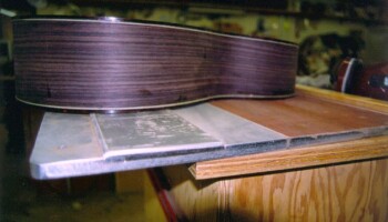 Once the binding is installed, Jim uses this form to true up the 3/4 degree top break angle for the neck set