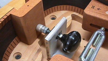 A detail of the rim support form in action, showing the clamp that presses the headblock against the form, and the turnbuckle clamp that presses the sides in place