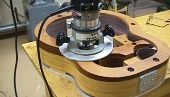 This fixture holds the assembled sides firmly in place and guides a router to trim the edge