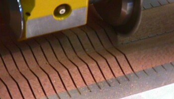 A right angle head is used to spin the carbide saw that cuts the relief slots in the lining. The right angle head alone cost $6500! It also is used to saw the fret slots in the fingerboards