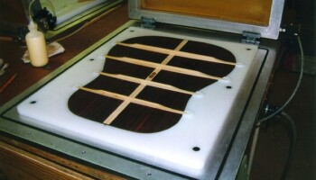 A back with braces set in the fixture in the open vacuum press